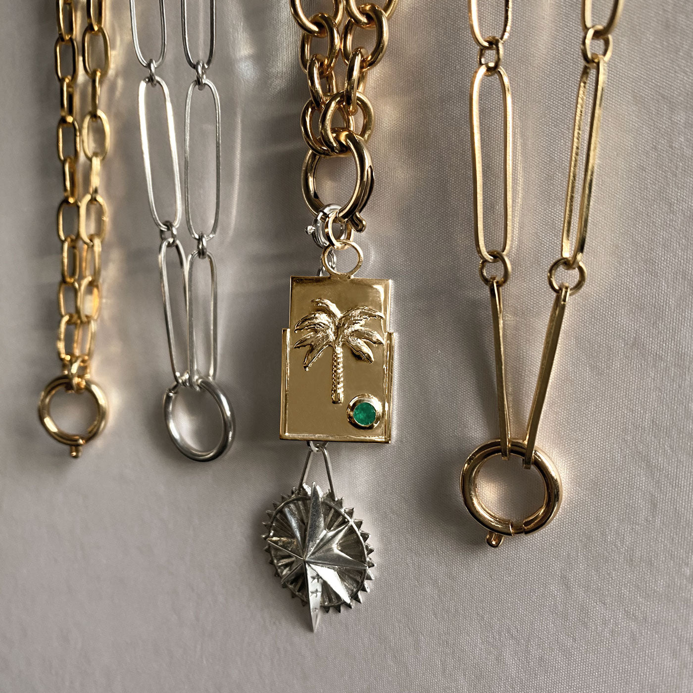 sterling silver and gold chains with star and palm tree medallions charms