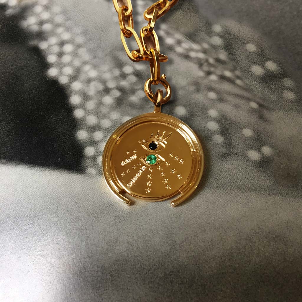 gold coin with emerald